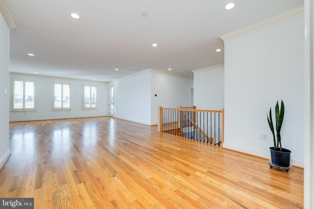 unfurnished room featuring ornamental molding and light hardwood / wood-style floors