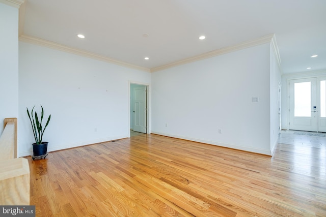 spare room with light hardwood / wood-style flooring and ornamental molding