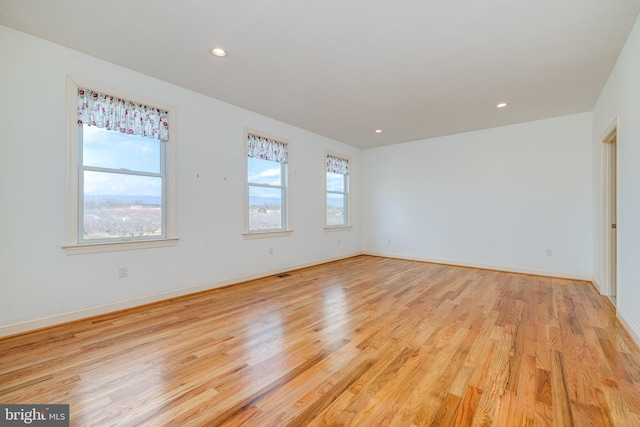 empty room with light hardwood / wood-style flooring