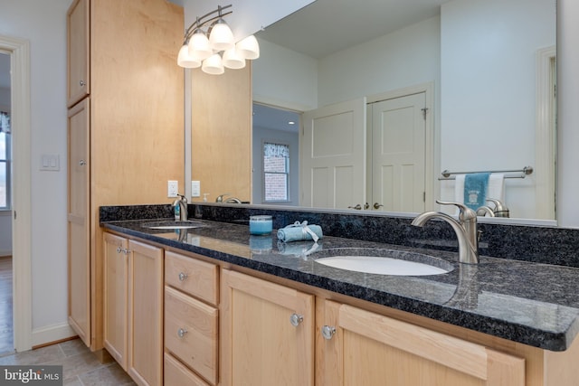 bathroom with an inviting chandelier and vanity