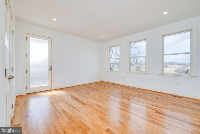 spare room with light hardwood / wood-style flooring