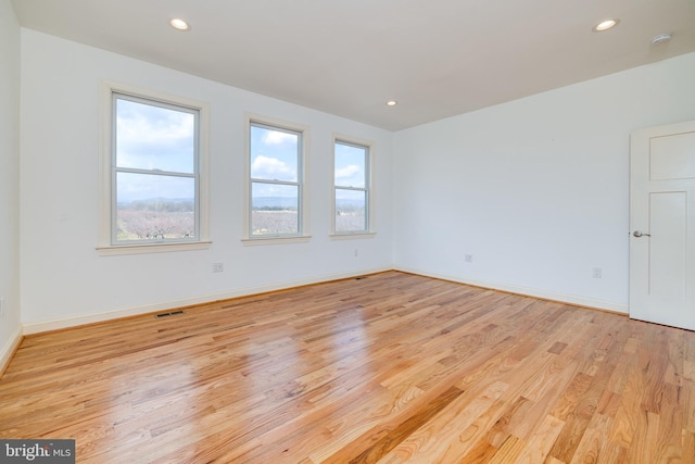 spare room with light wood-type flooring