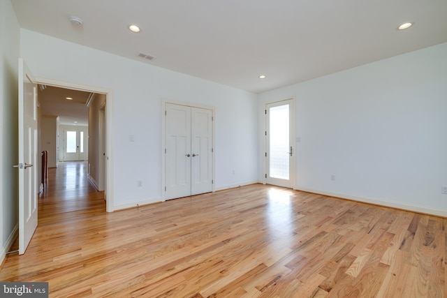 empty room with light hardwood / wood-style floors