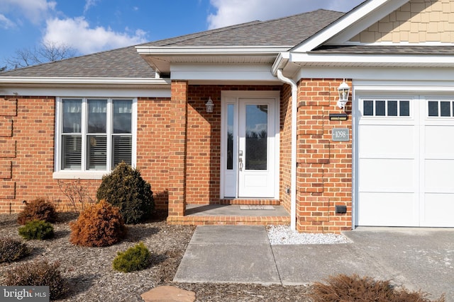 doorway to property with a garage