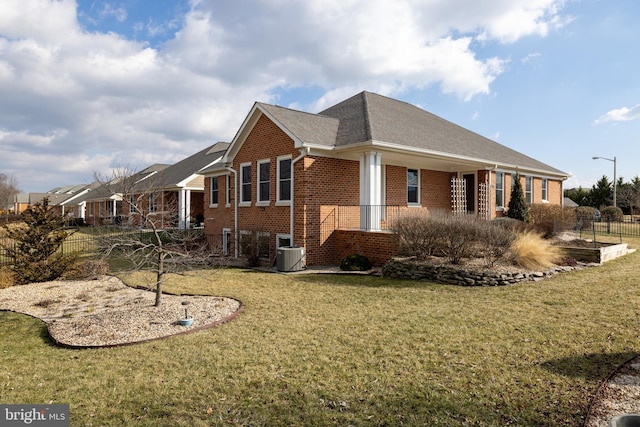 view of home's exterior with cooling unit and a lawn