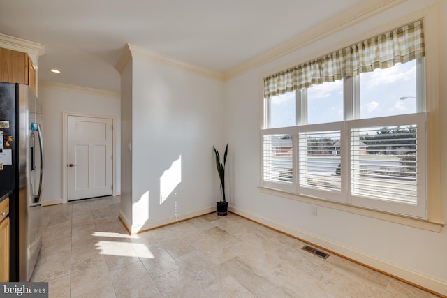 interior space with stainless steel fridge with ice dispenser and ornamental molding