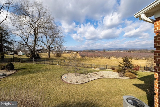 view of yard with a rural view and central AC unit