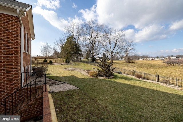 view of yard with a rural view