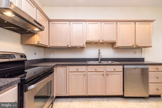 kitchen featuring stainless steel appliances, sink, exhaust hood, and light brown cabinets