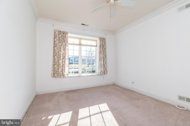 unfurnished room featuring crown molding, light colored carpet, and ceiling fan