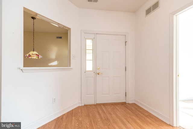 entryway with hardwood / wood-style floors