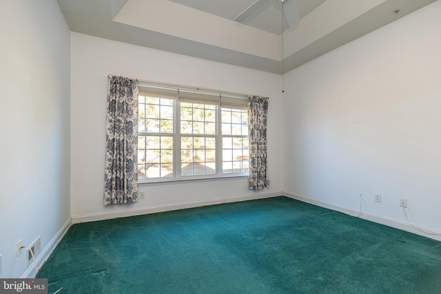 unfurnished room featuring dark carpet