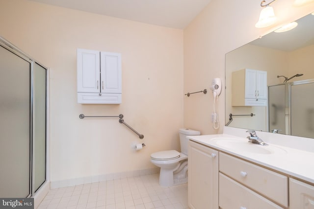 bathroom with tile patterned flooring, vanity, toilet, and a shower with shower door