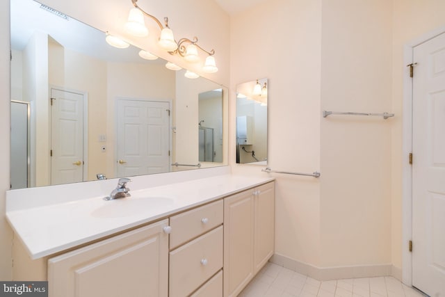 bathroom with vanity, tile patterned flooring, and a shower with door