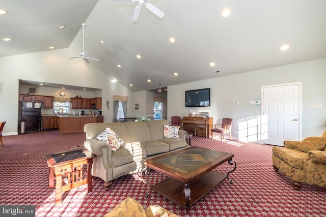 living room featuring ceiling fan, high vaulted ceiling, and dark carpet