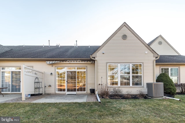 back of property featuring a yard, a patio area, and central air condition unit