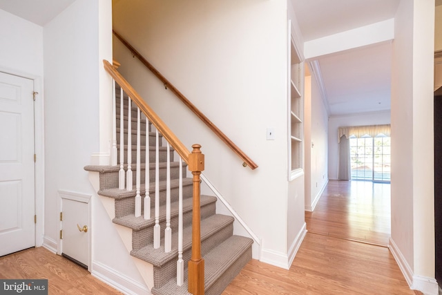 stairway with hardwood / wood-style floors