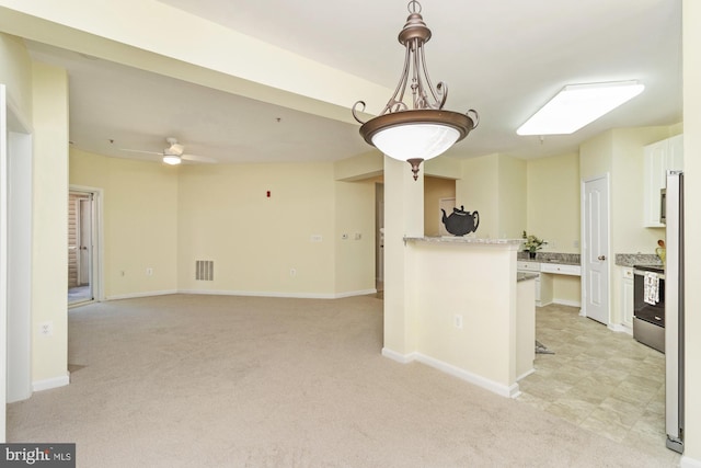 400 Symphony Cir Unit 136E, Cockeysville, MD 21030 - kitchen featuring white cabinets, range, light carpet, and baseboards