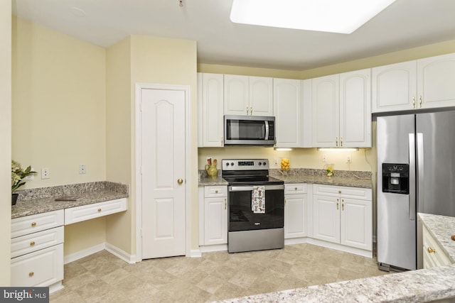 400 Symphony Cir Unit 136E, Cockeysville, MD 21030 - kitchen featuring appliances with stainless steel finishes, white cabinetry, light stone countertops, and baseboards