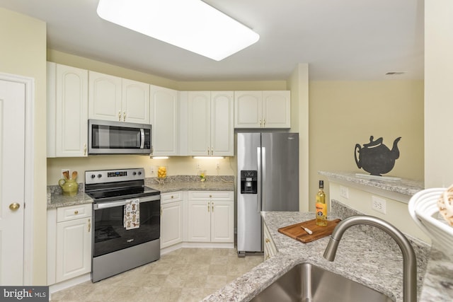 400 Symphony Cir Unit 136E, Cockeysville, MD 21030 - kitchen with appliances with stainless steel finishes, light stone countertops, and white cabinetry