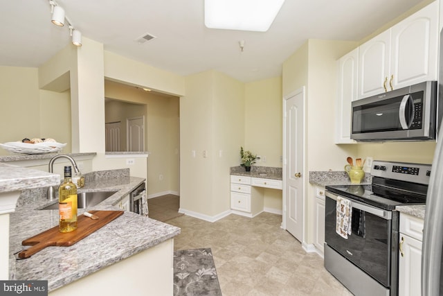 400 Symphony Cir Unit 136E, Cockeysville, MD 21030 - kitchen with stainless steel appliances, a sink, white cabinetry, and light stone countertops