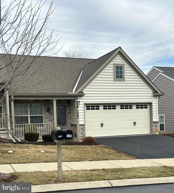 view of front of property with a garage and covered porch