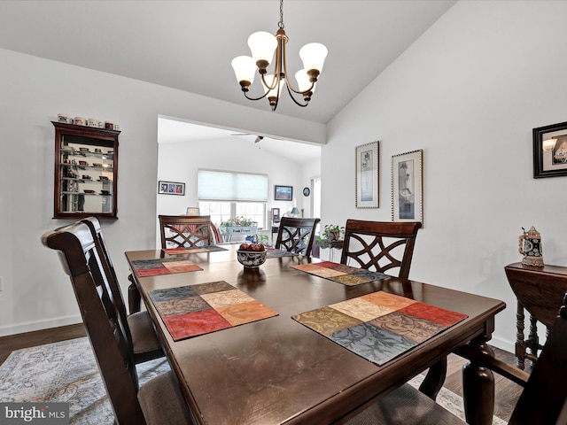 dining room featuring lofted ceiling, dark wood-type flooring, and a chandelier