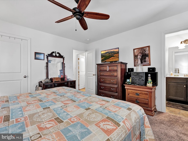 bedroom featuring ceiling fan and ensuite bath