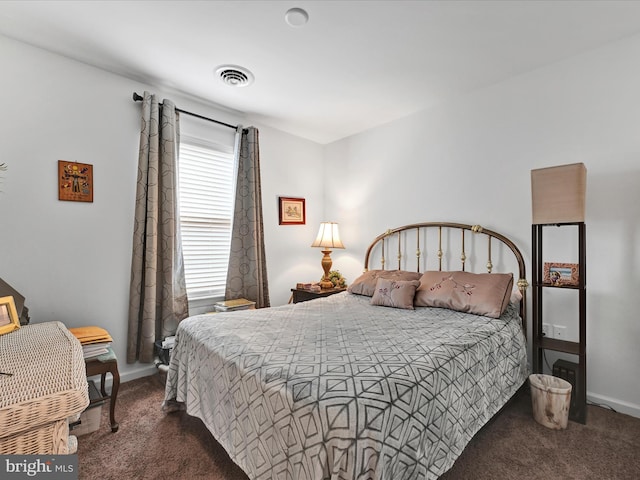 bedroom featuring dark colored carpet