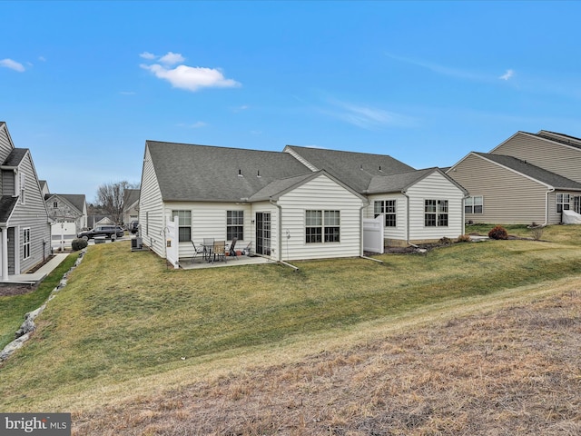 rear view of house featuring a yard and a patio area