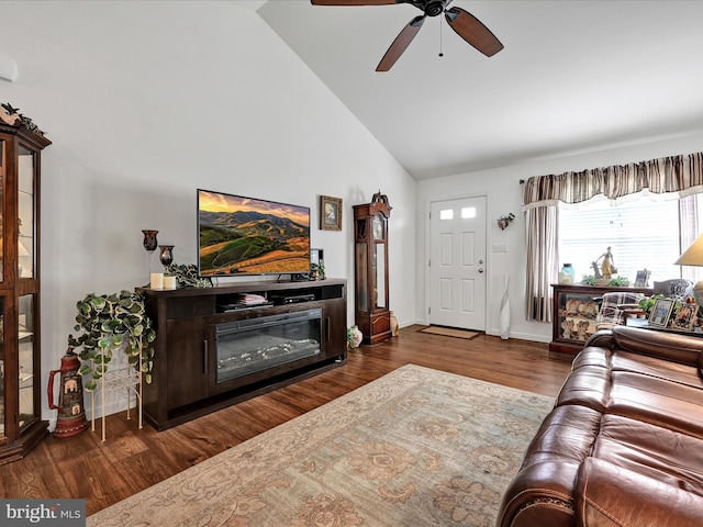 living room featuring ceiling fan, dark hardwood / wood-style floors, and high vaulted ceiling