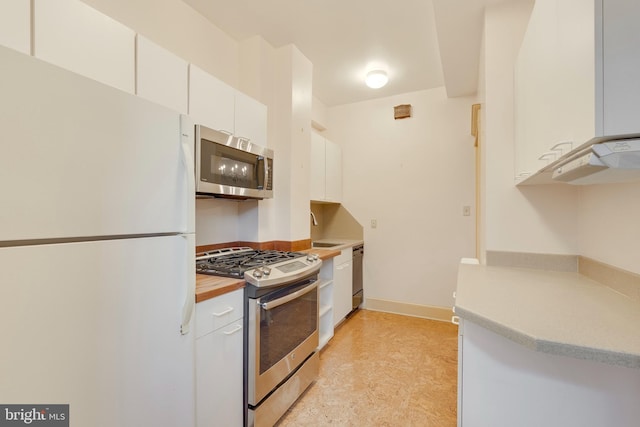 kitchen with white cabinetry, sink, and stainless steel appliances