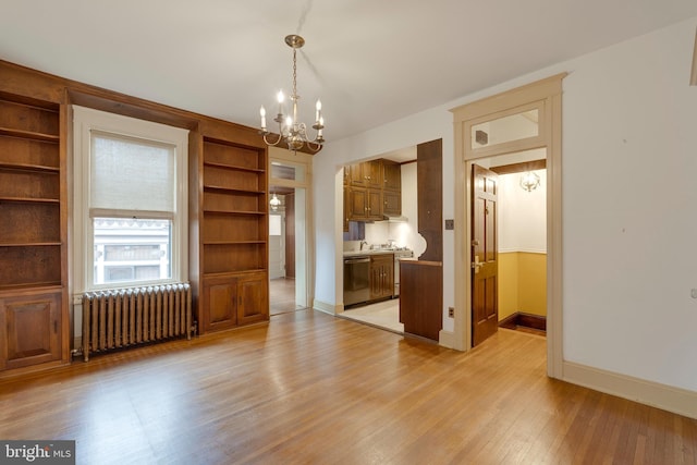 interior space with radiator heating unit, light hardwood / wood-style floors, and a notable chandelier