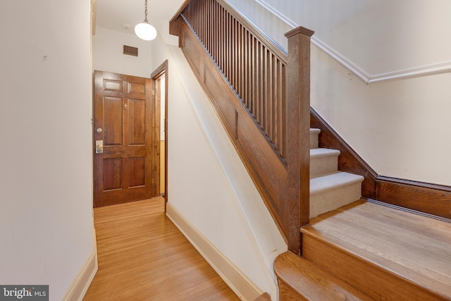 stairs featuring hardwood / wood-style floors