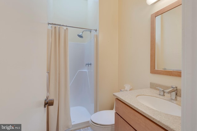 bathroom with vanity, toilet, and walk in shower