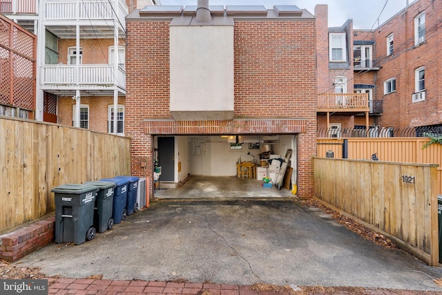 rear view of property with a garage