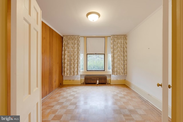 unfurnished living room featuring radiator and crown molding