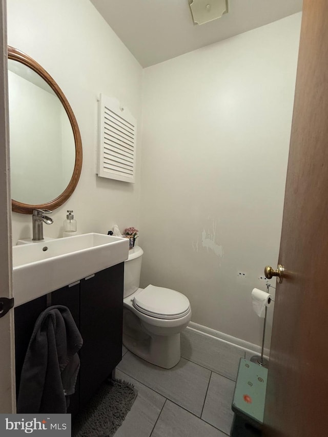 bathroom featuring vanity, tile patterned flooring, and toilet