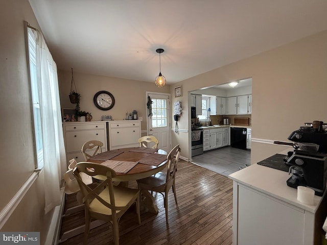 dining area with hardwood / wood-style flooring and sink