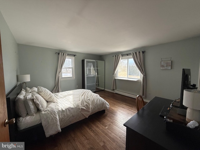 bedroom featuring a baseboard radiator and dark hardwood / wood-style floors