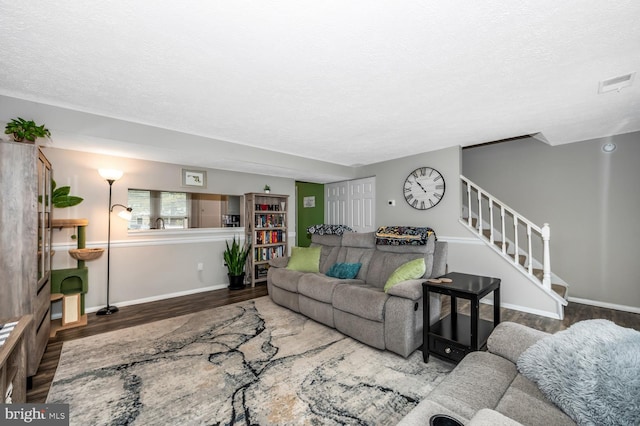 living room featuring hardwood / wood-style floors and a textured ceiling