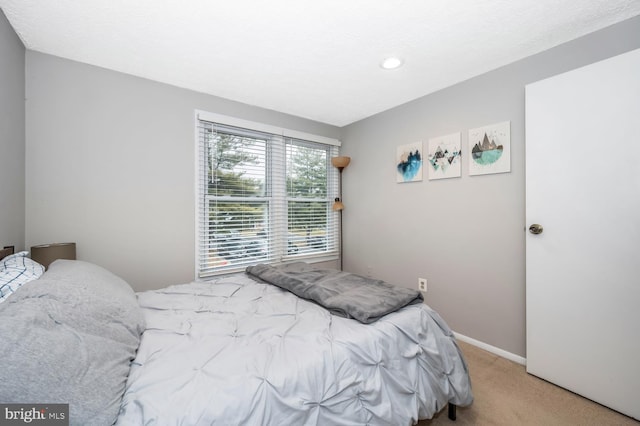 bedroom featuring light carpet