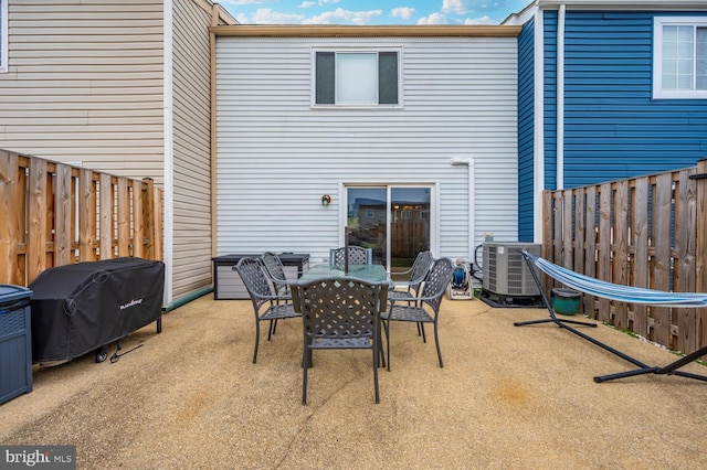 rear view of property with central AC and a patio area