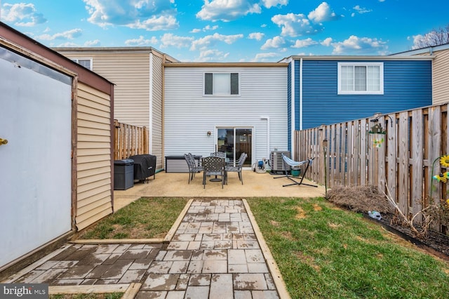 rear view of house featuring a yard, a patio area, and central air condition unit