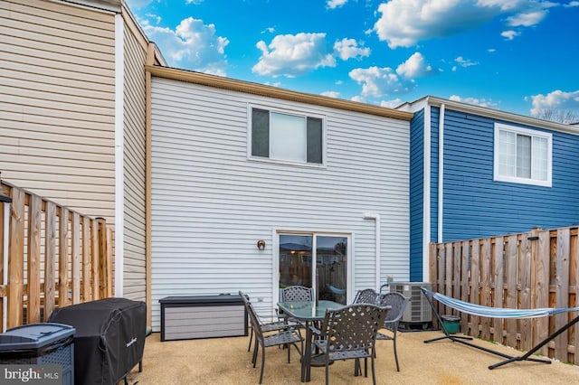 rear view of property with a patio and central air condition unit