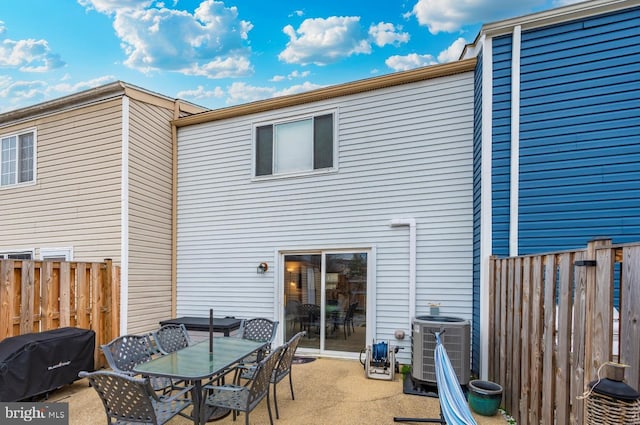 rear view of property with central AC and a patio area