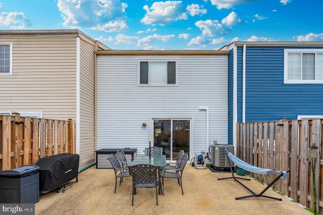 rear view of house with central air condition unit and a patio area