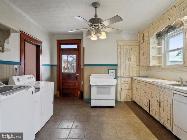 washroom with washing machine and clothes dryer, plenty of natural light, sink, and a textured ceiling