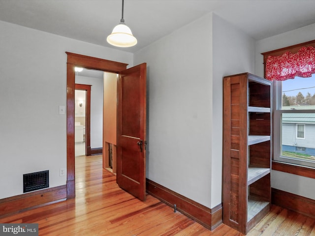 empty room with light hardwood / wood-style flooring