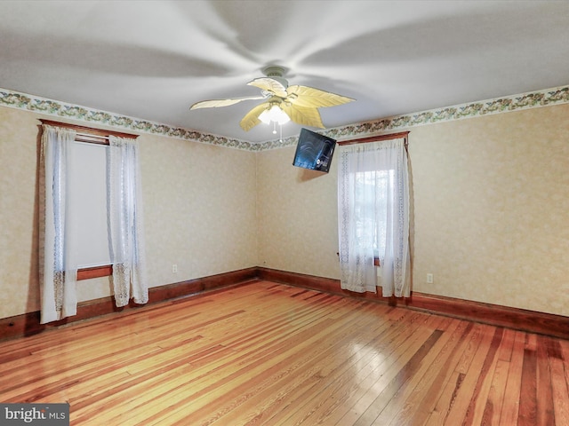 spare room featuring light hardwood / wood-style floors and ceiling fan